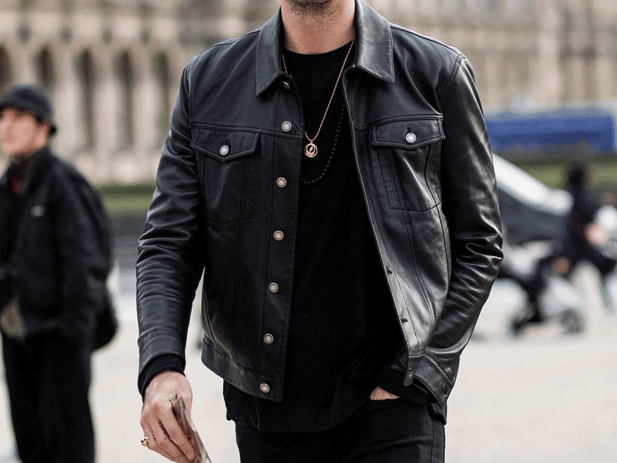 Man in a black shirt underneath a black leather jacket