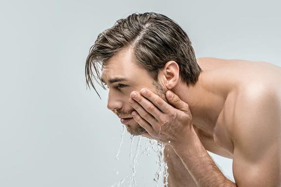 Side of a man washing his face