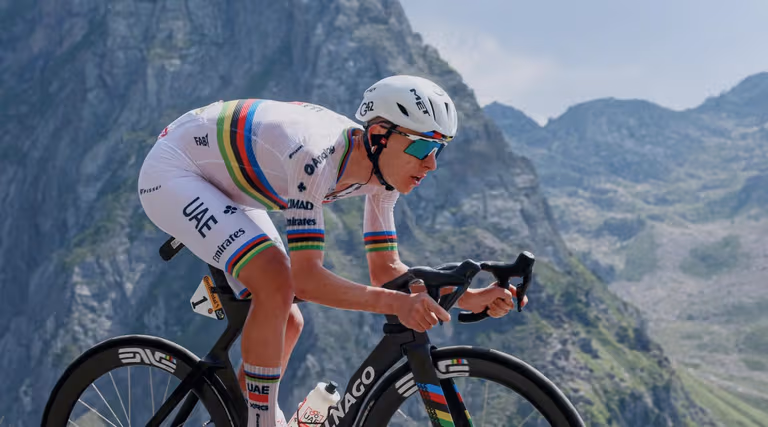 Tadej Pogacar climbing in the world champion's jersey for UAE Team Emirates XRG at the Tour de France