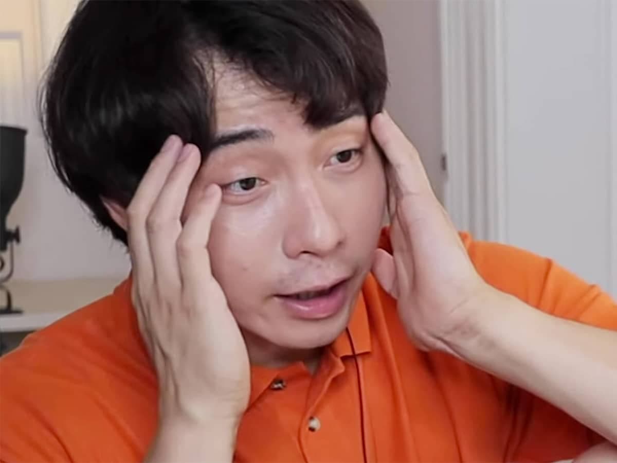 Comedian Uncle Roger holding his head in disbelief