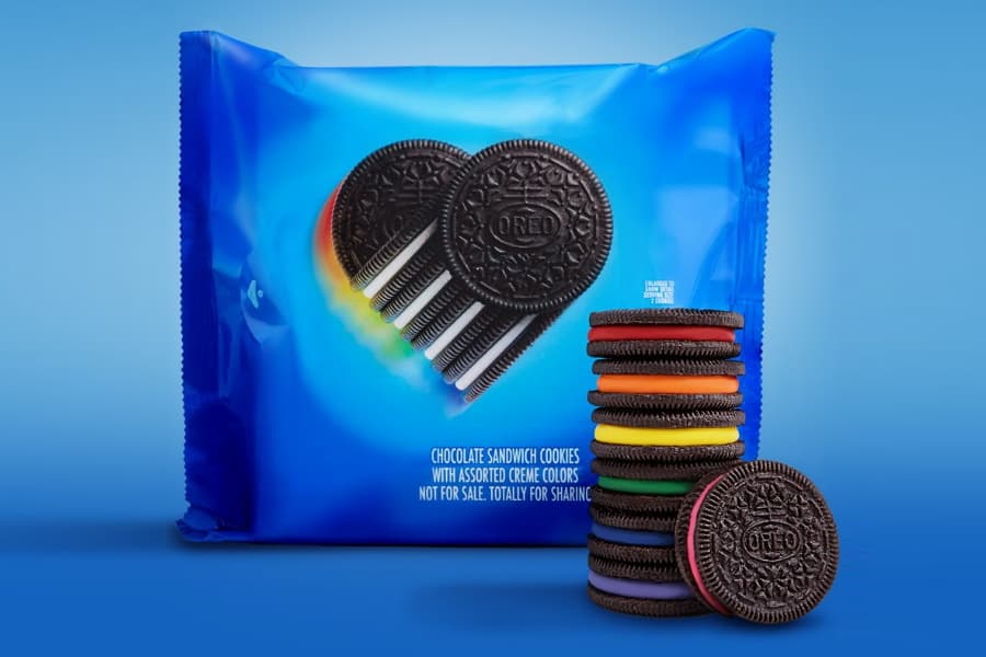 Rainbow Oreos stacked on each other in front of a pack of Rainbow Oreos