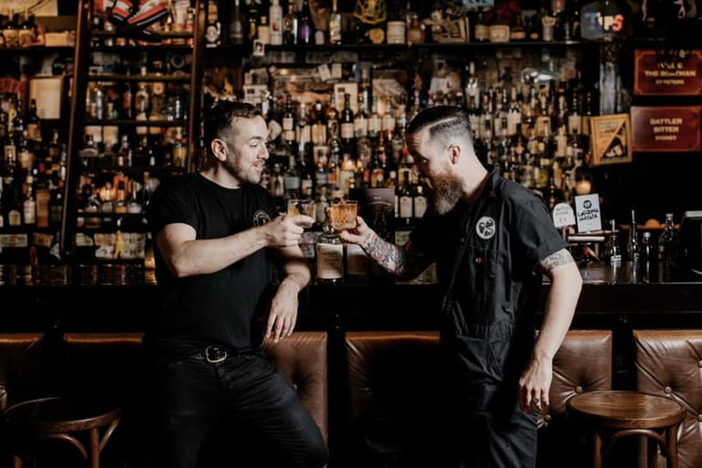 Ramblin Rascal Tavern and The Gidley holding glasses
