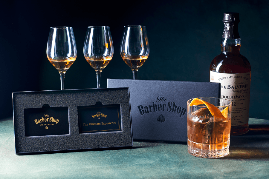 Balvenie whiskey bottle and glasses with The Barber Shop ultimate experience box