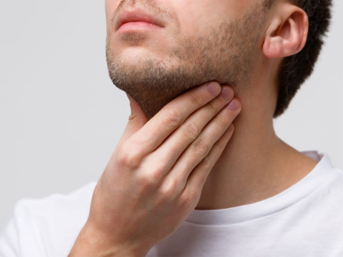 Man touching his double chin