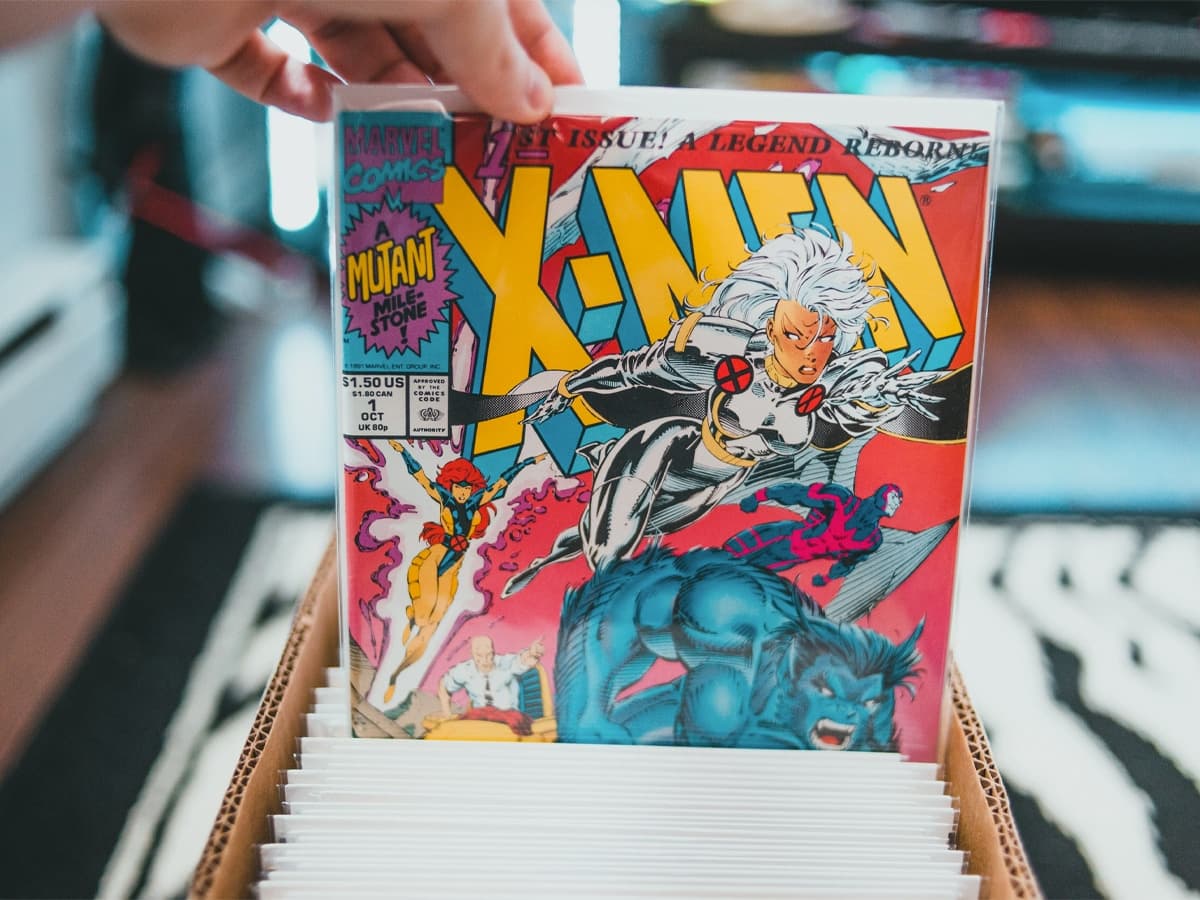 Hand picking out a comic from a box of comics