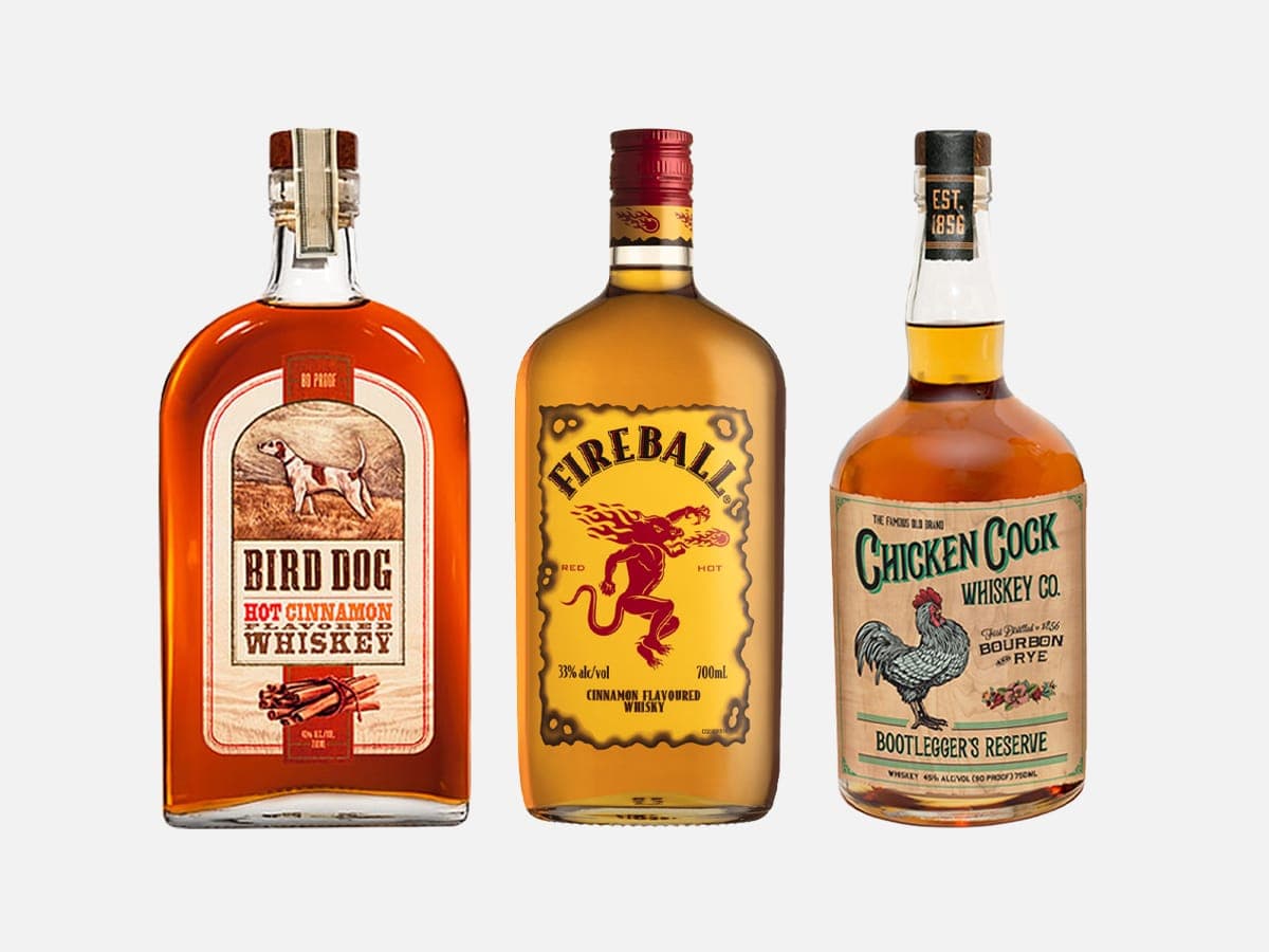 Three different cinnamon flavoured spirits with a grey background