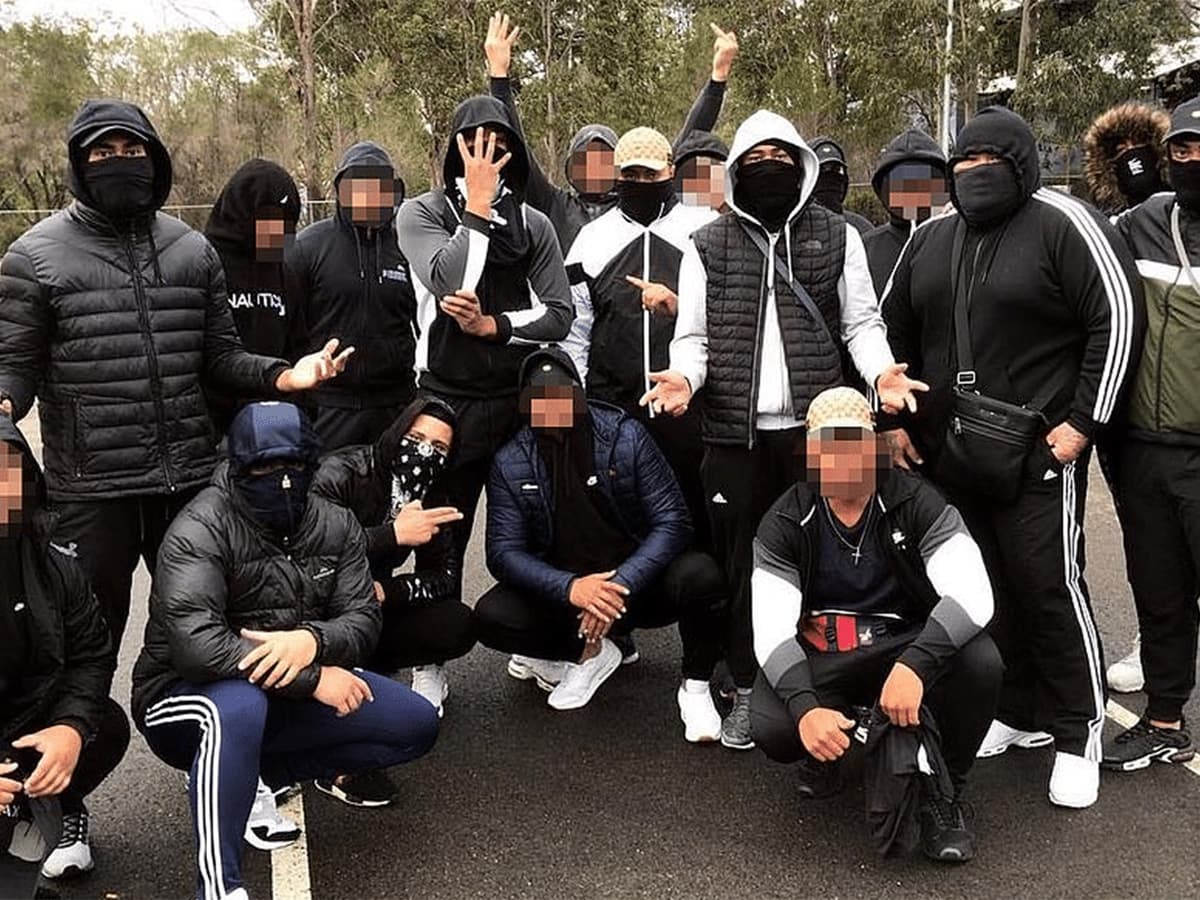 Group of men wearing masks with their faces blurred