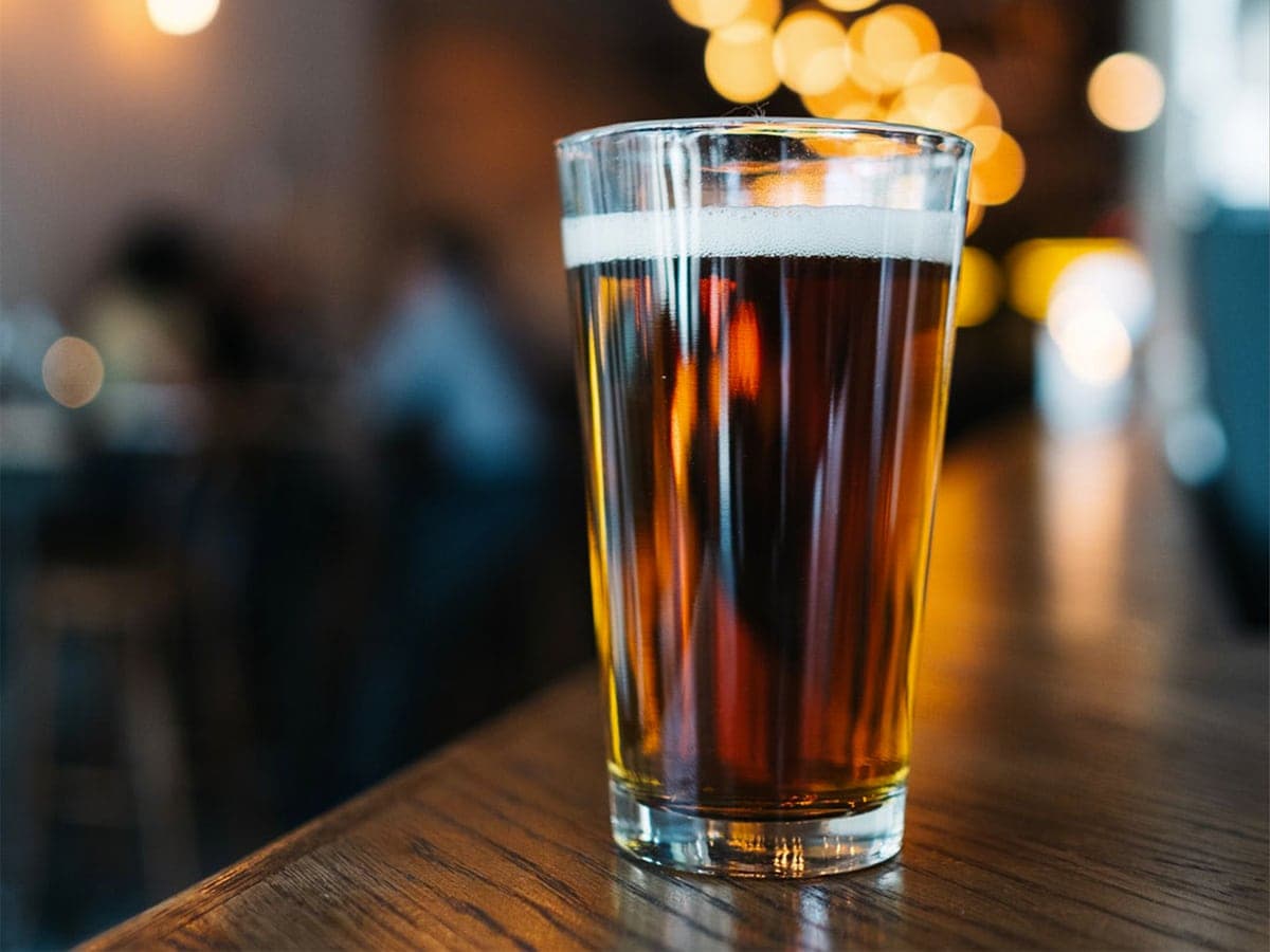 Glass of beer set on a wooden bar