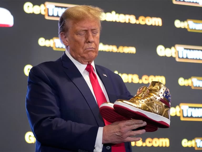 Donald trump sneakers in hand