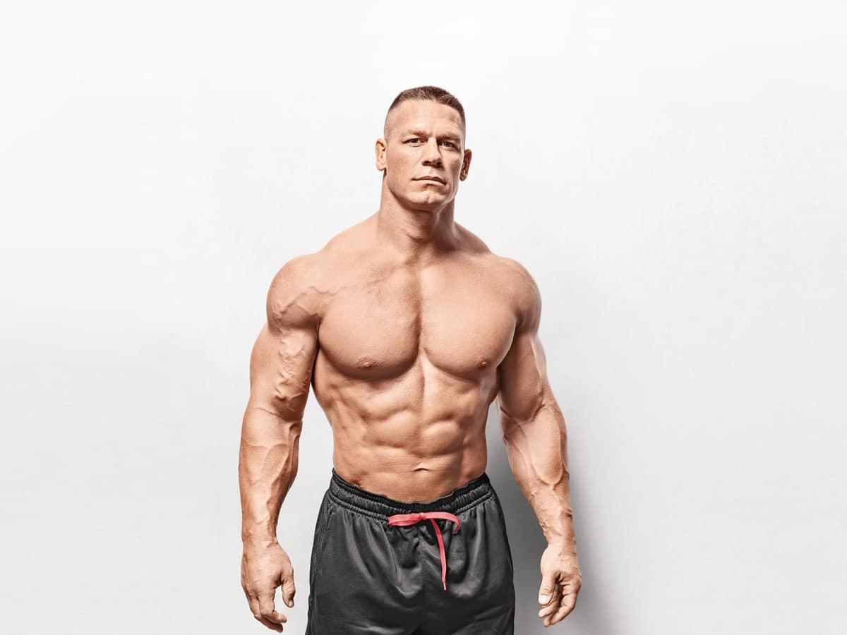 Premium Photo  Muscular man posing in the gym with a towel on his  shoulders. fitness concept.