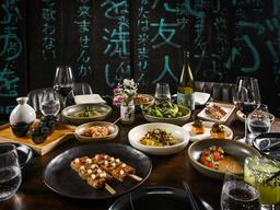 asian fusion dishes on a wooden table with japanese characters on a background wall