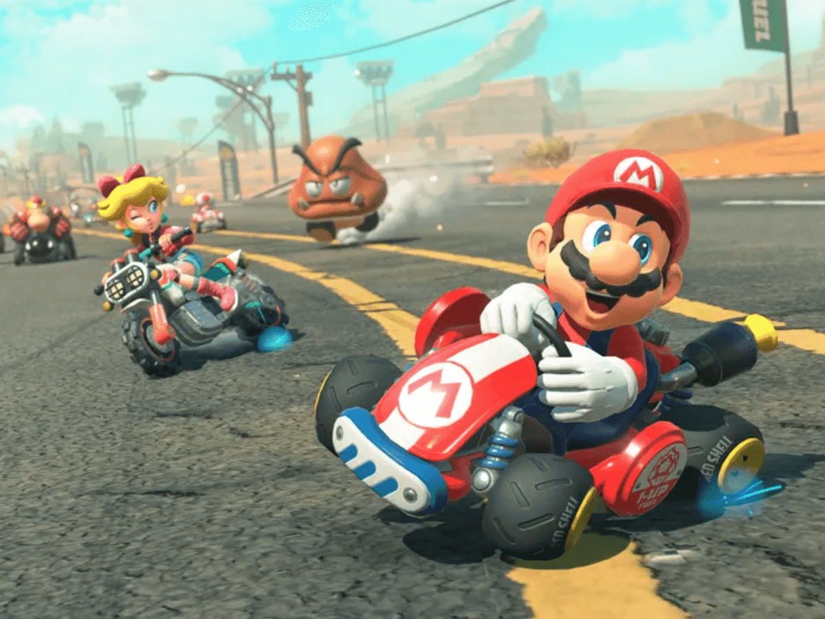 Plumber character racing his kart down a desert roadway