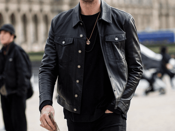 Man in a black shirt underneath a black leather jacket