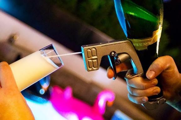 A hand using Bubbly Blaster Champagne Gun