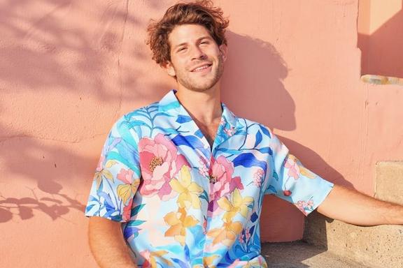 Model in a blue and pink Hawaiian shirt