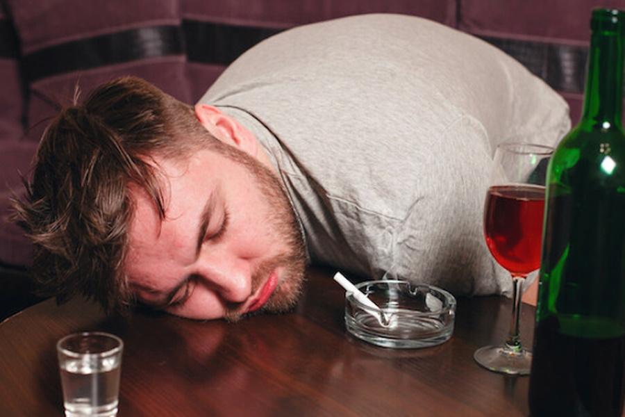 A drunk man sleeping on table