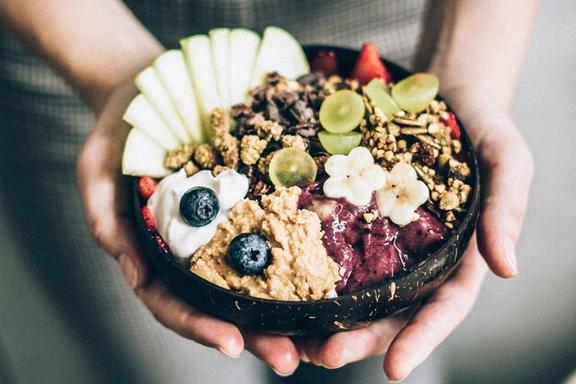 Pair of hands holding an Acai bowl