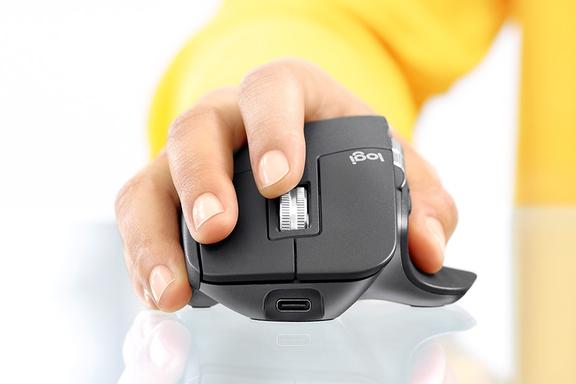 A hand holding Logitech MX Master 3 Mouse