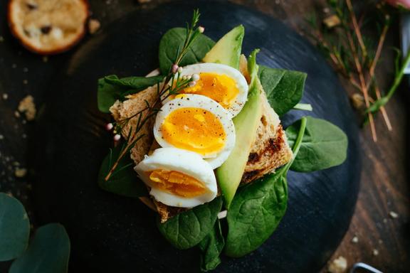 Eggs on a bread over leaves