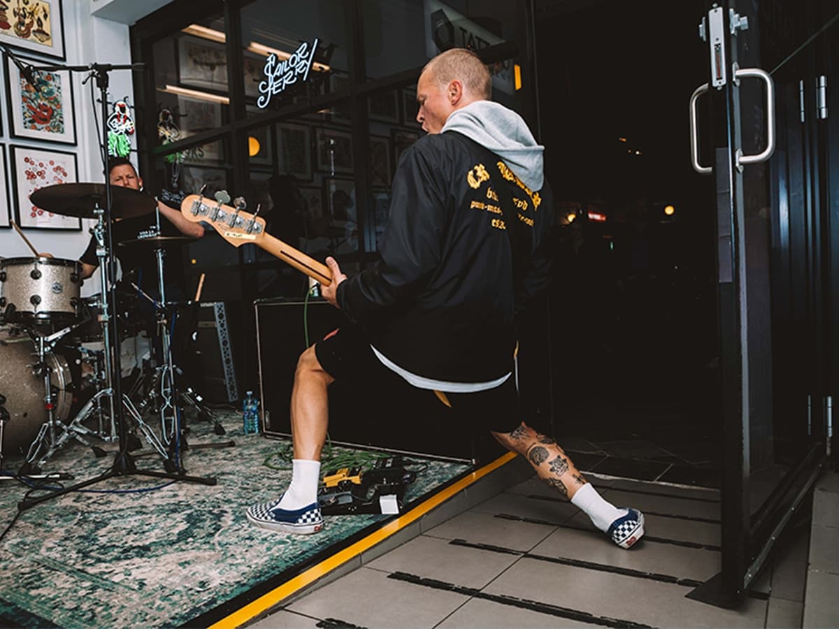 Back view of man playing electric guitar