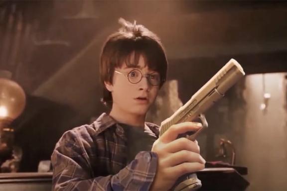 Harry Potter holding a gun