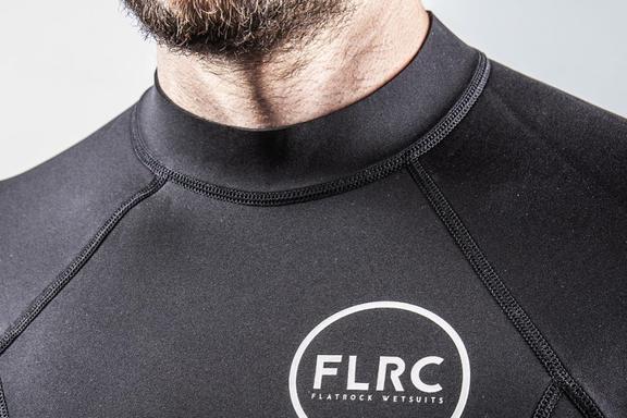 A man's neck and upper chest in a Flatrock Wetsuit top