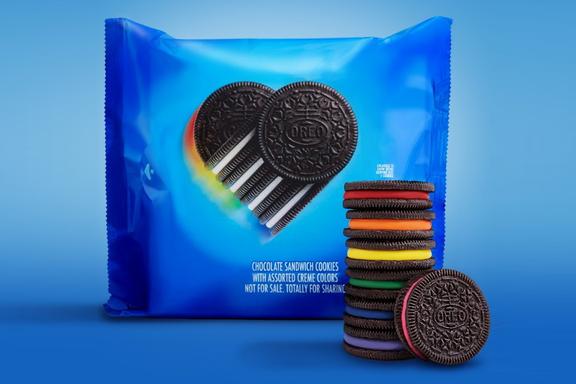 Rainbow Oreos stacked on each other in front of a pack of Rainbow Oreos