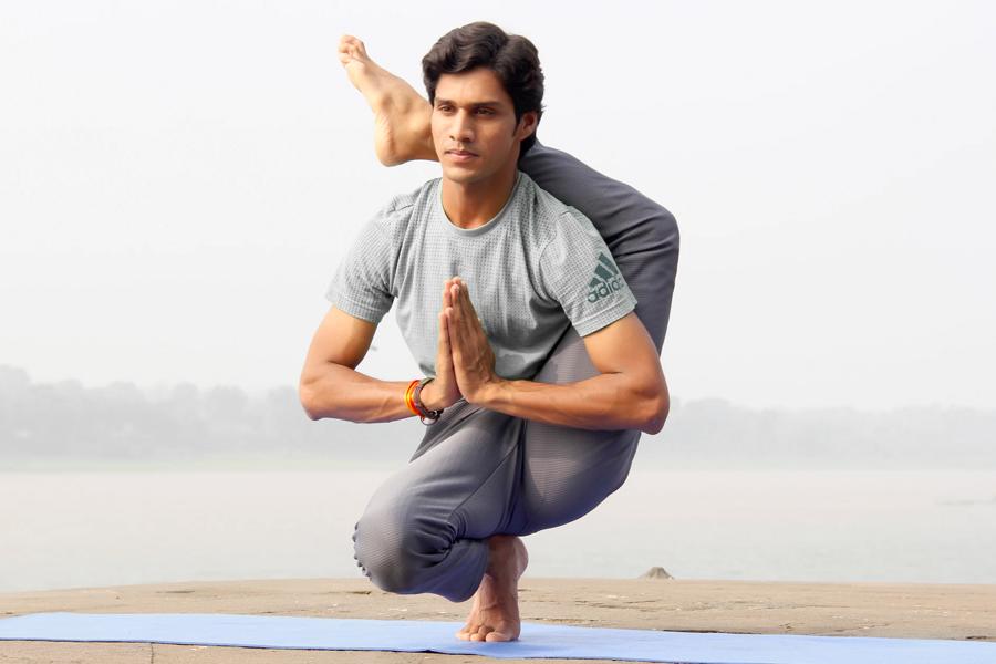 A man doing yoga on a yoga mat