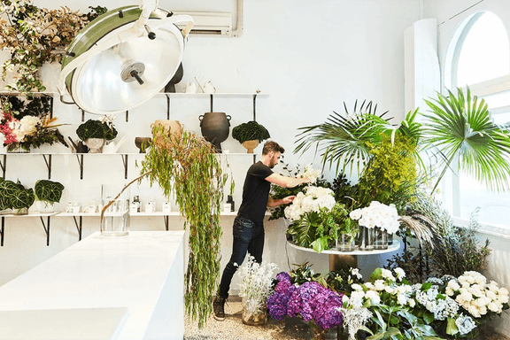 A man taking care of flowers in the nursery