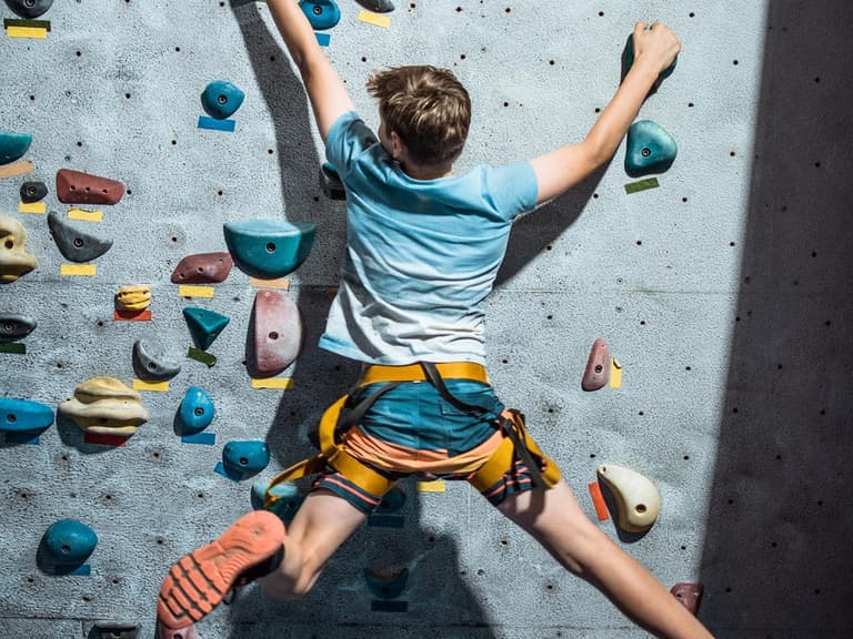 boy on climbing wall