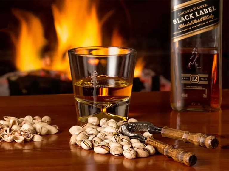 a glass of whisky and a bottle of johnnie walker black label