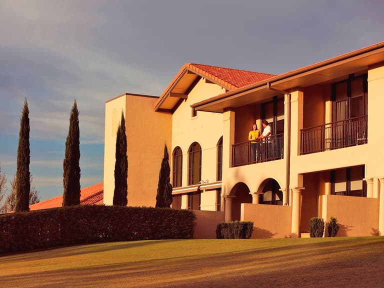 romantic couple on balcony of château elan at the vintage