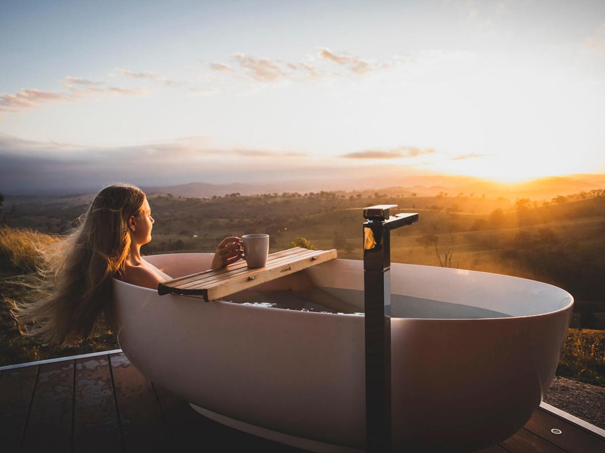 woman relaxing in outdoor bath at Sierra Escape Mudgee