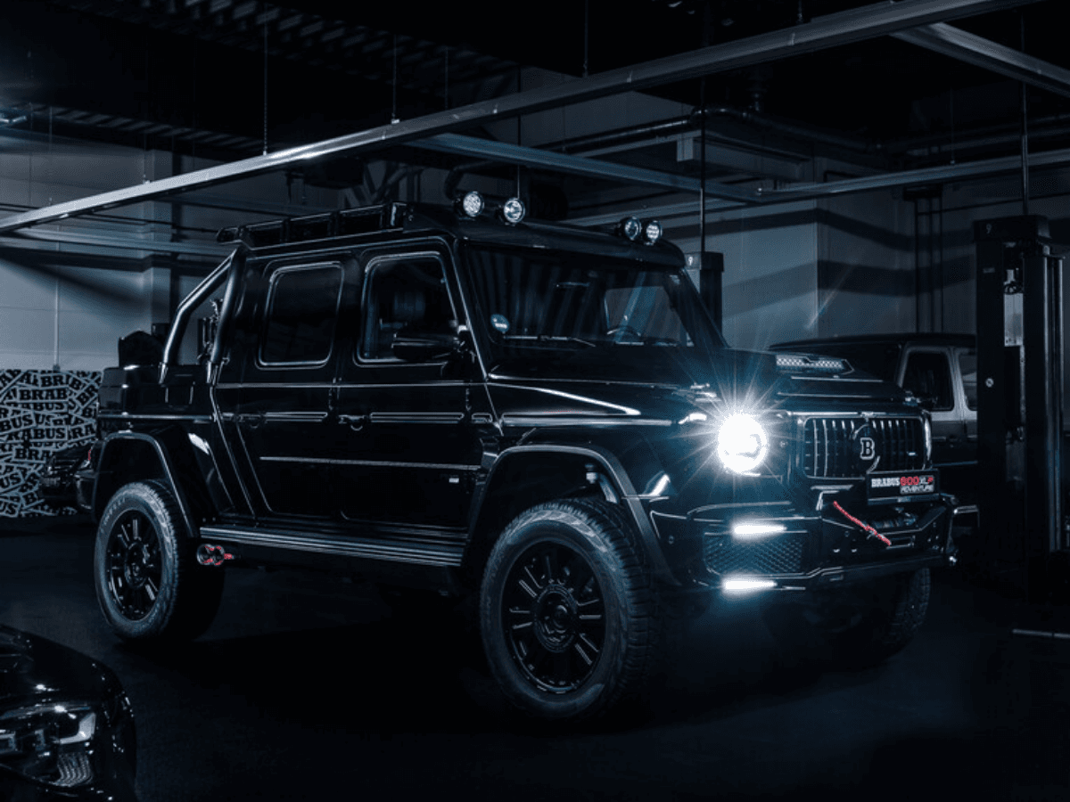 Brabus 800 Adventure XLP Superblack in a dimly lit garage, showcasing its sleek black exterior and rugged design.