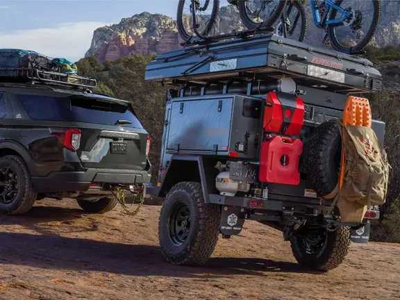 An off-road camper trailer attached to an SUV