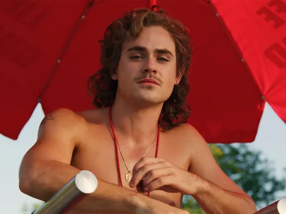 Dacre Montgomery on the lifeguard chair
