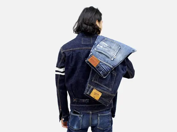 Back of a man with two jeans on his shuolder