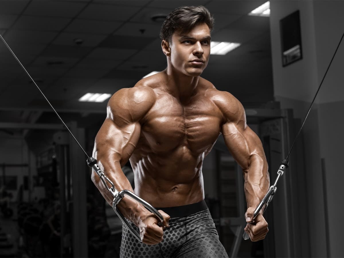 Muscular man doing a cable crossover workout