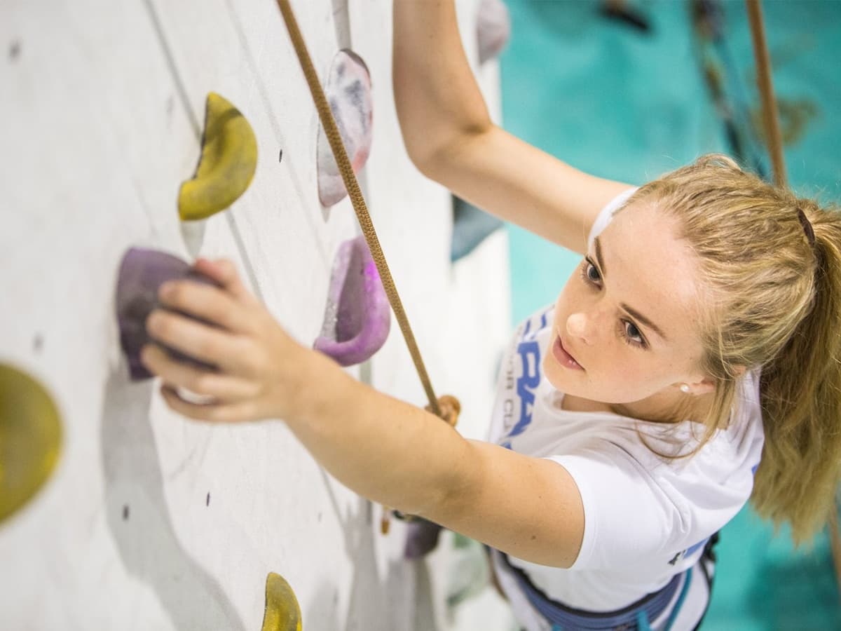 female kid rock climbing