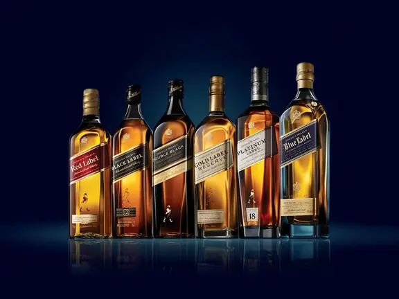 Six different Johnnie Walker premium whisky bottles displayed against a dark blue background | Image: Diageo