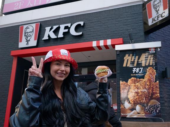 Kentucky Fly Chicken winner Lisa Wenban with the 'cult' KFC Wafu Cutlet Burger in Japan | Image: KFC Australia
