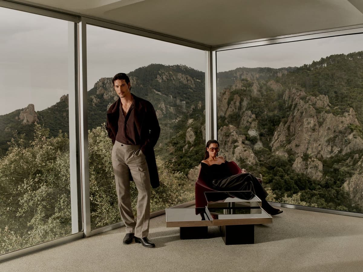 Two male models in Calibre winter tailoring at a glass pavilion in the South of France