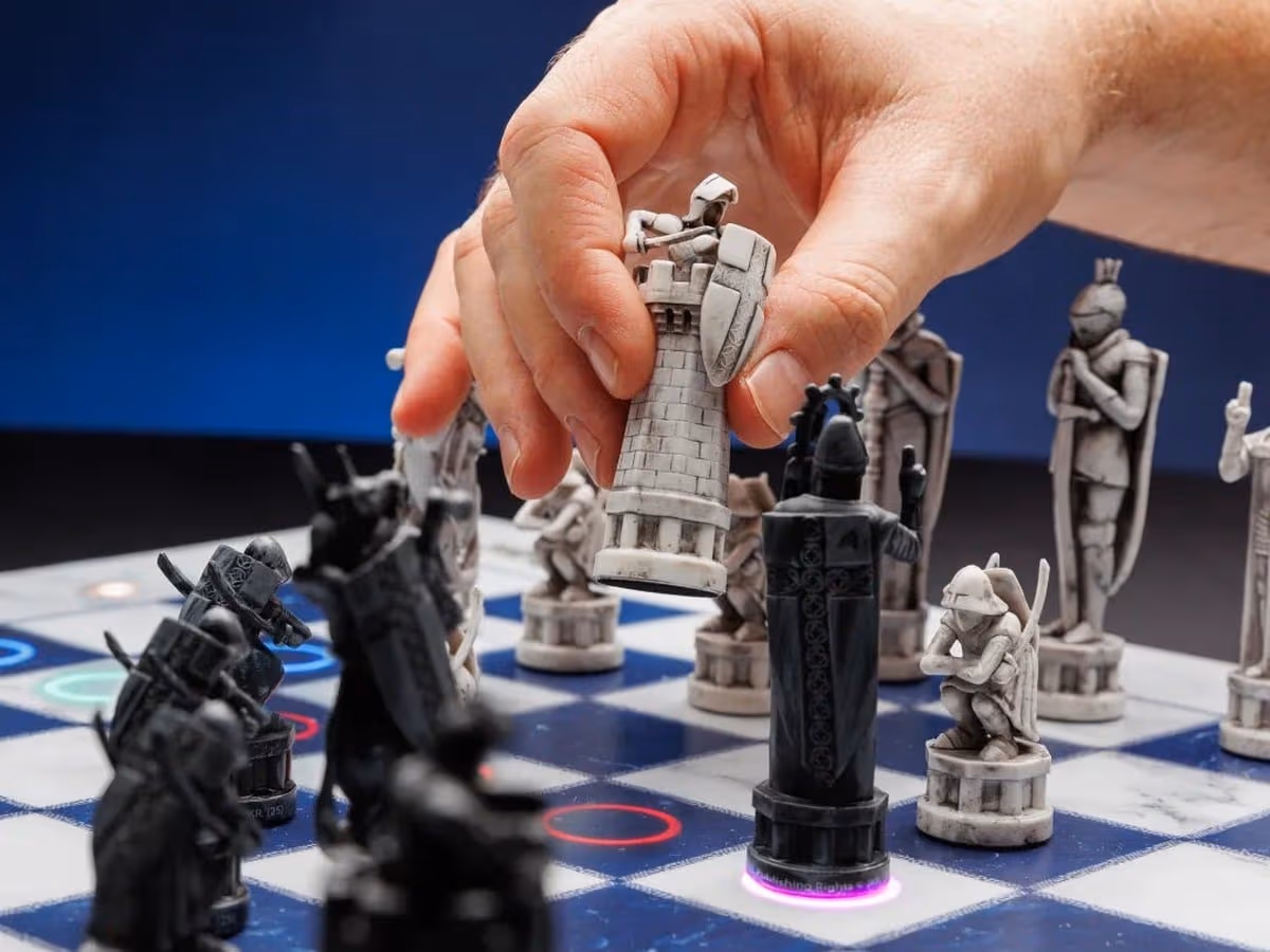 Hand moving a piece on the GoChess Wizard Lite Harry Potter chess board