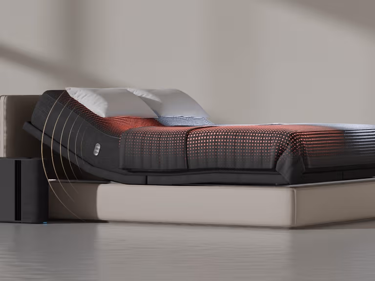 Eight Sleep Pod 5 on a bed with the Hub beside it, showing the cover's temperature zones