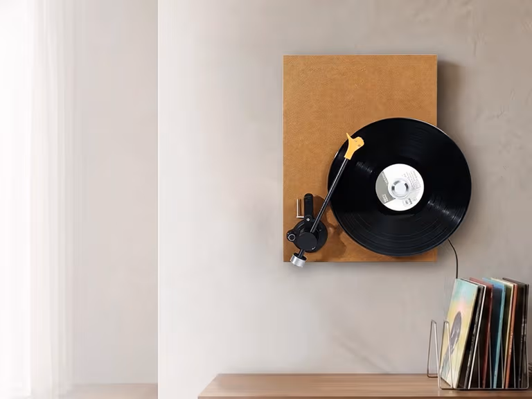 ECHOV DY040 wall-mounted vinyl player spinning a record above a sideboard, with a record rack alongside