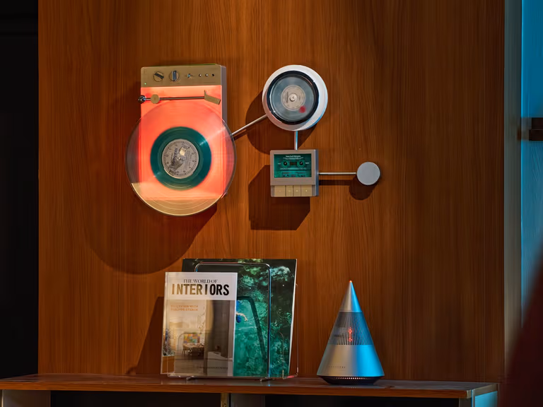 TRETTITRE LP3 wireless vinyl player, DP3 CD player and CP3 cassette player mounted on a timber wall above a console table