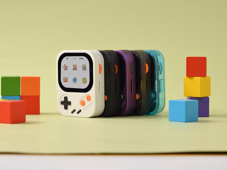 Five Hidizs AP30 Music Boy players stacked in a row in white, black, purple and translucent teal, surrounded by primary-coloured toy blocks
