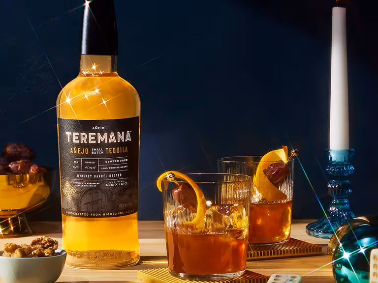 Three bottles of Teremana small batch tequila arranged together against a warm, earthy backdrop.