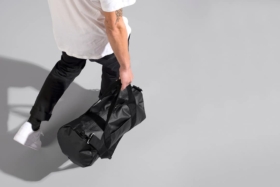 High angle shot of a man with a black duffle bag