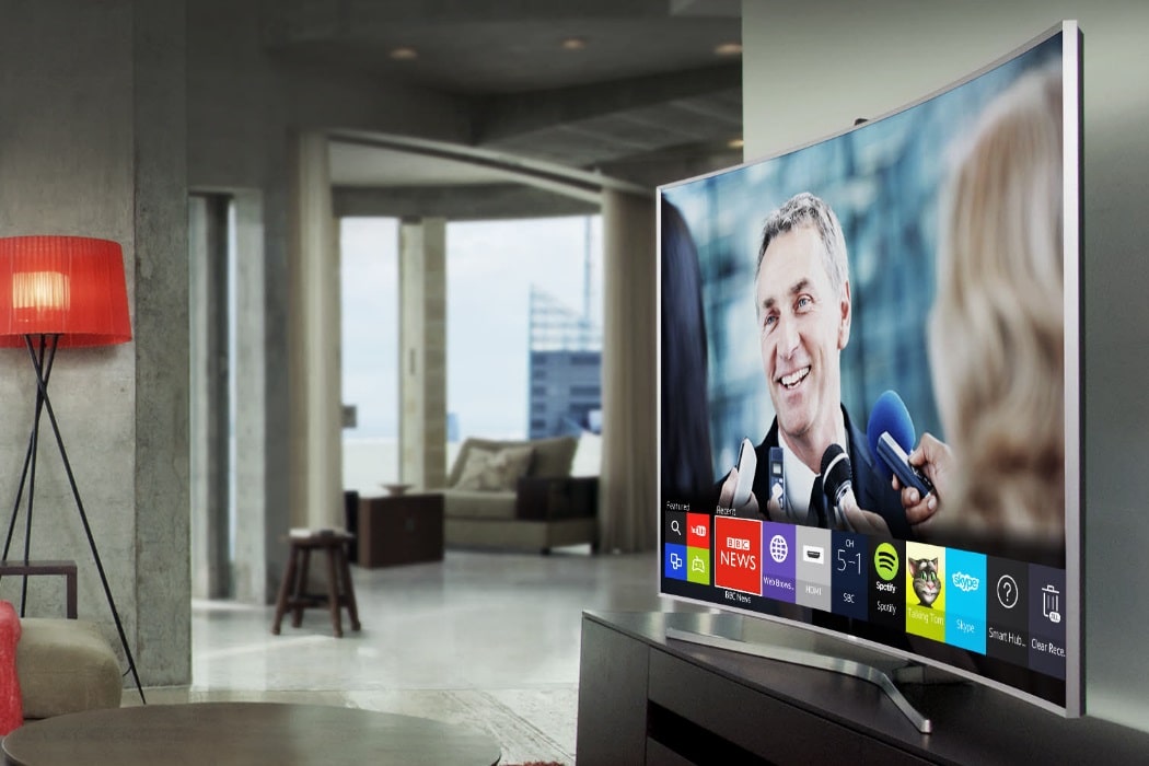 man smiling in the tv screen